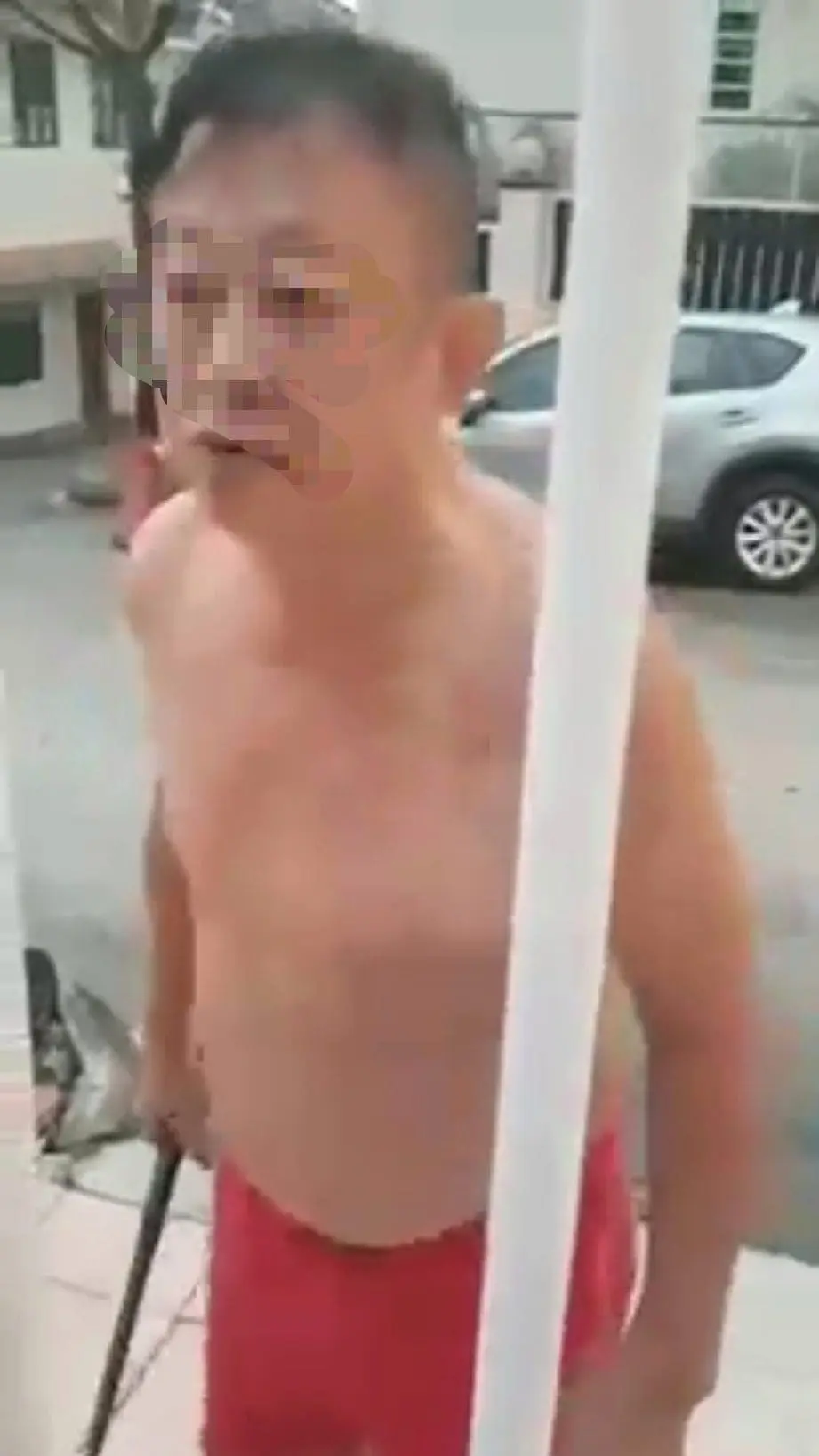 Man swears and hits neighbour's gate with metal rod over a parking spot