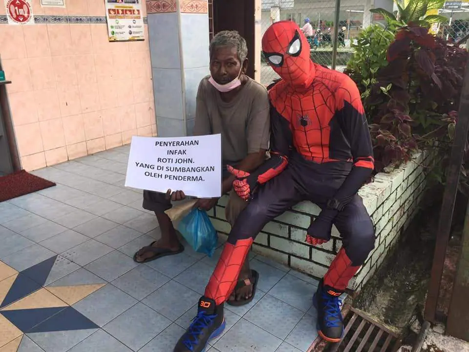 Policeman "employs" Spiderman to sell Roti John to help needy folks