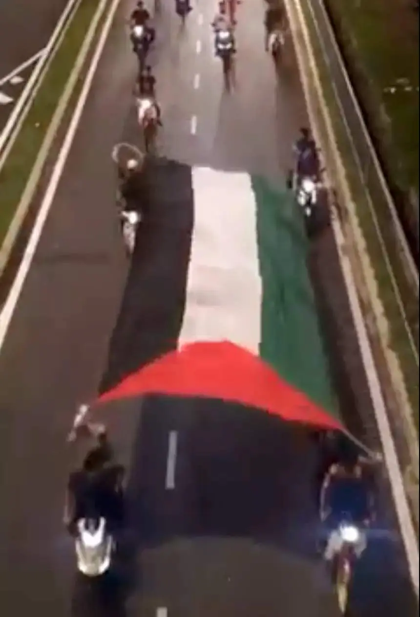 Motorcyclists detained for reckless driving while displaying the Palestinian flag