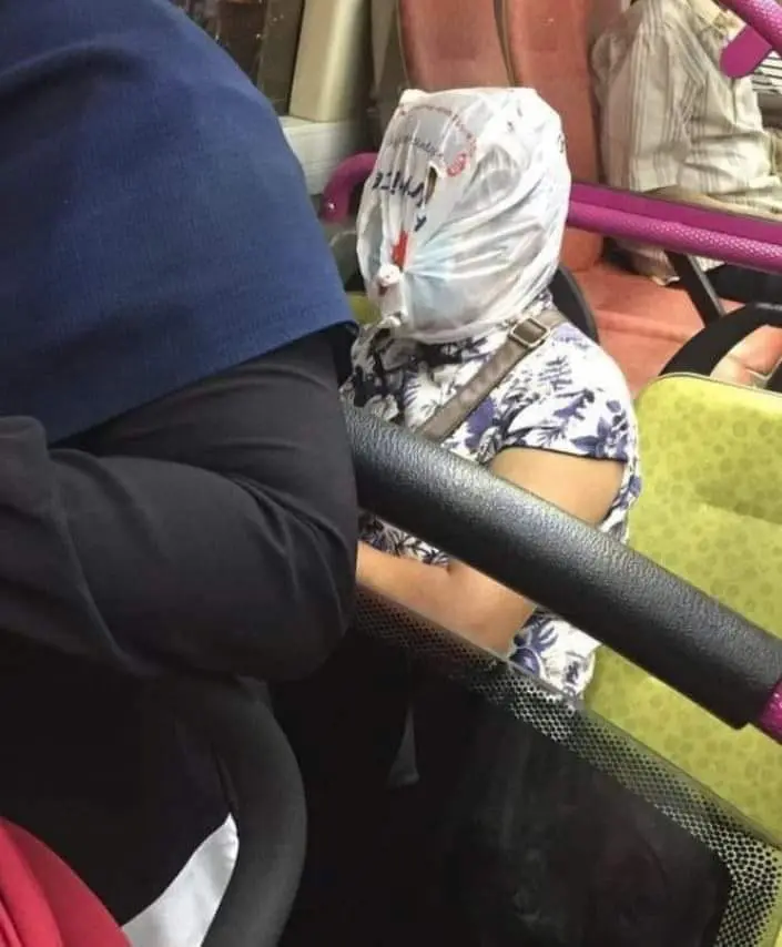 Woman uses plastic bag as "face shield" during bus ride, becomes an Internet sensation