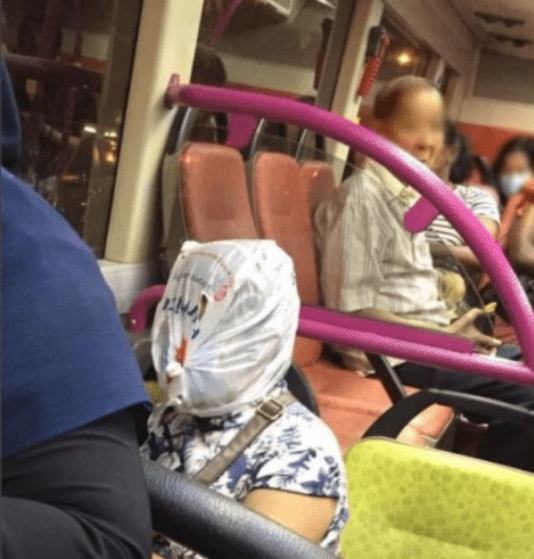 Woman uses plastic bag as "face shield" during bus ride, becomes an Internet sensation