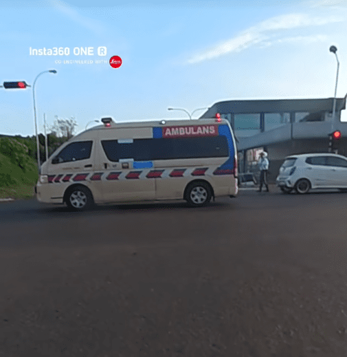 Traffic police direct ambulance