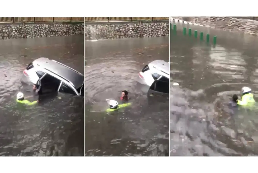 Malaysian Traffic Police Risk his life to rescue driver trapped in flash flood
