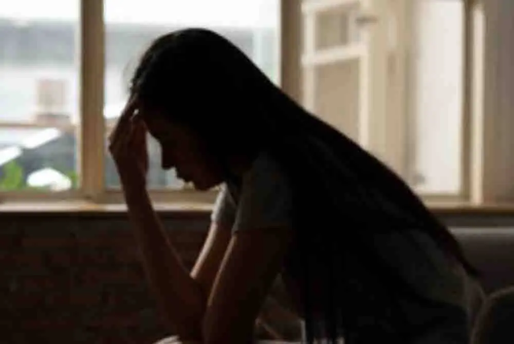 woman seemingly frustrated by the window 