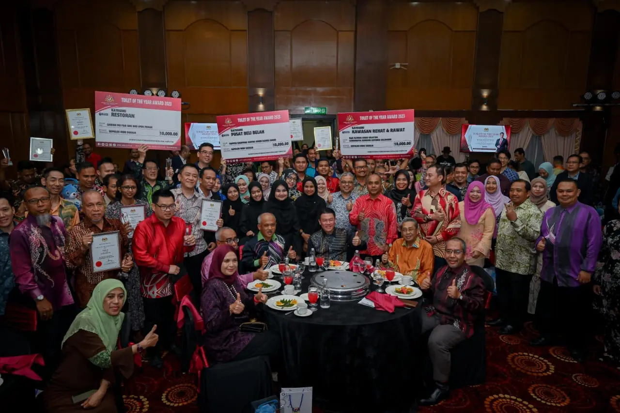 The winners show their awards and certificates after receiving the toilet of the year award for 2023