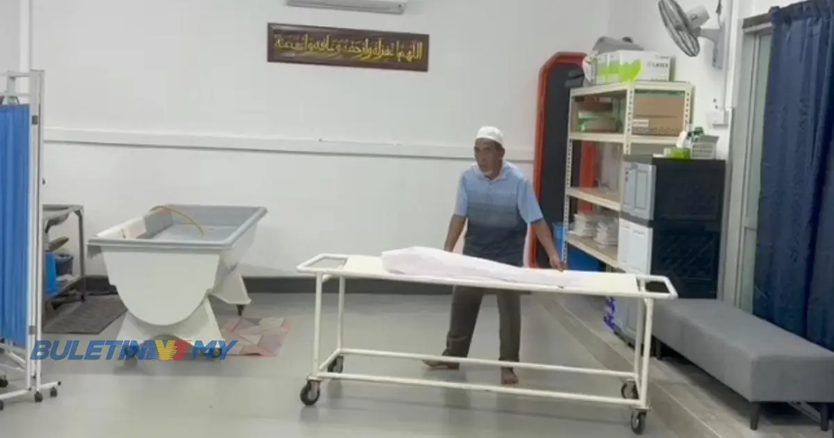 a man moving the stretcher that has the body of a baby corpse