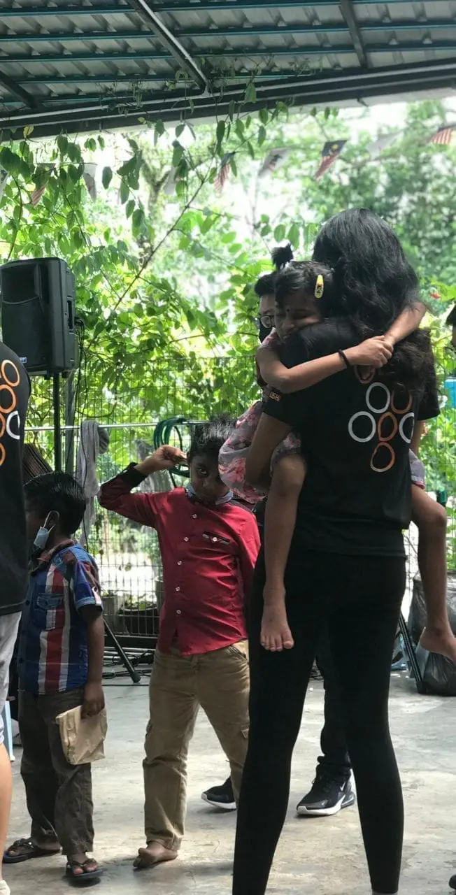 Lishalliny Kanaran hugging a kid