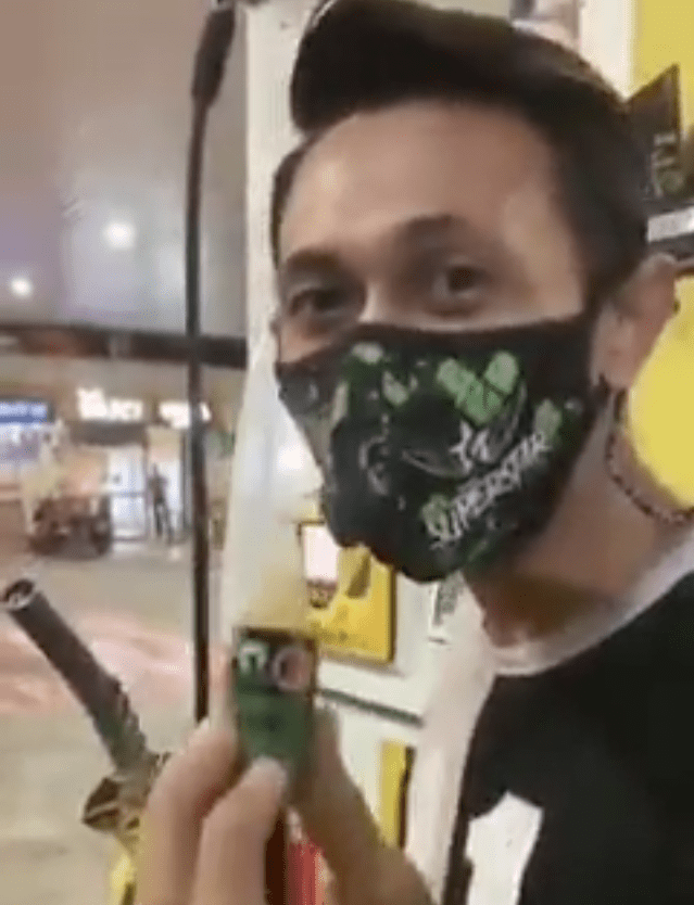 Man showing octane booster before pumping petrol
