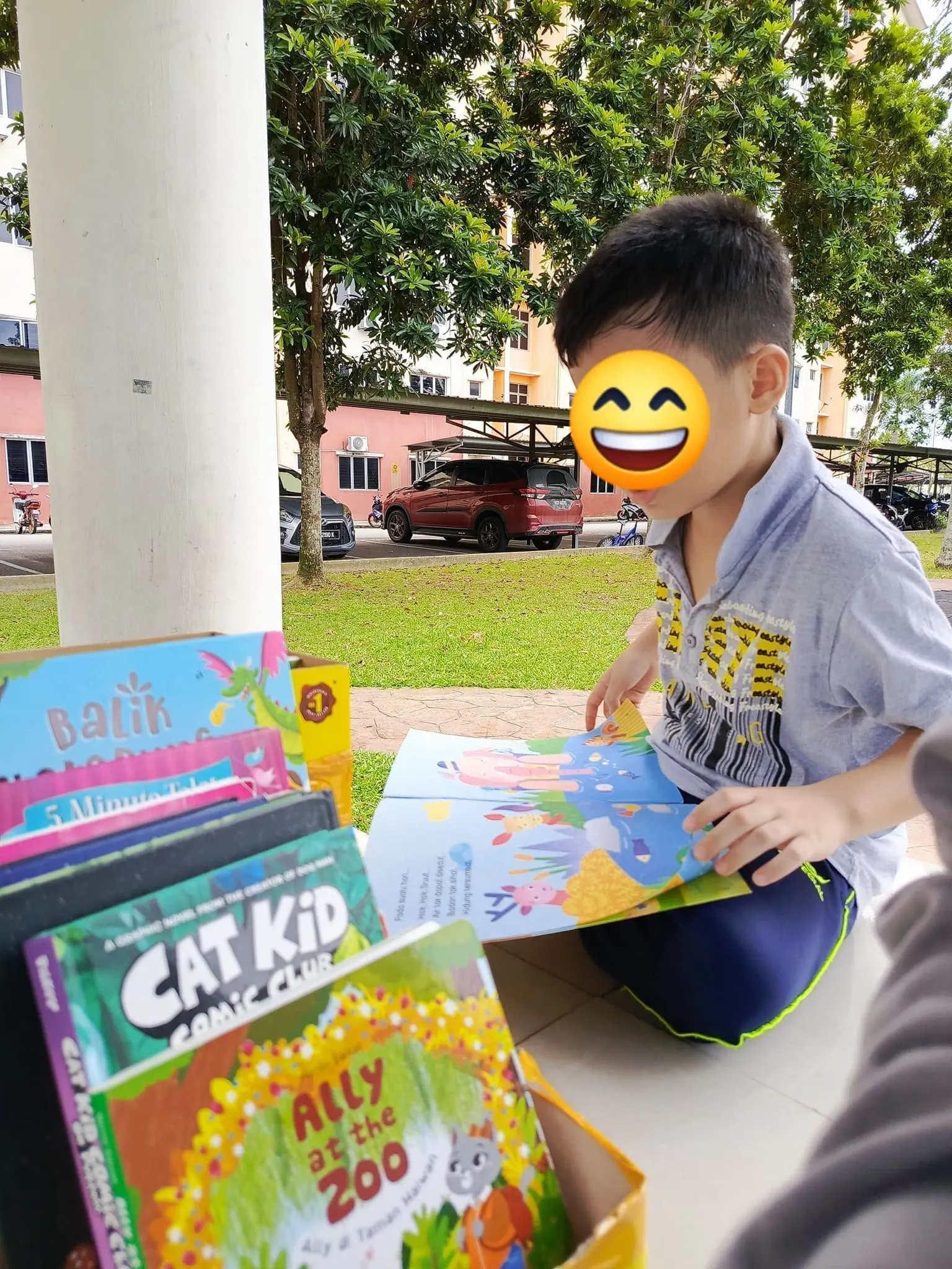 a little boy reading book outdoor