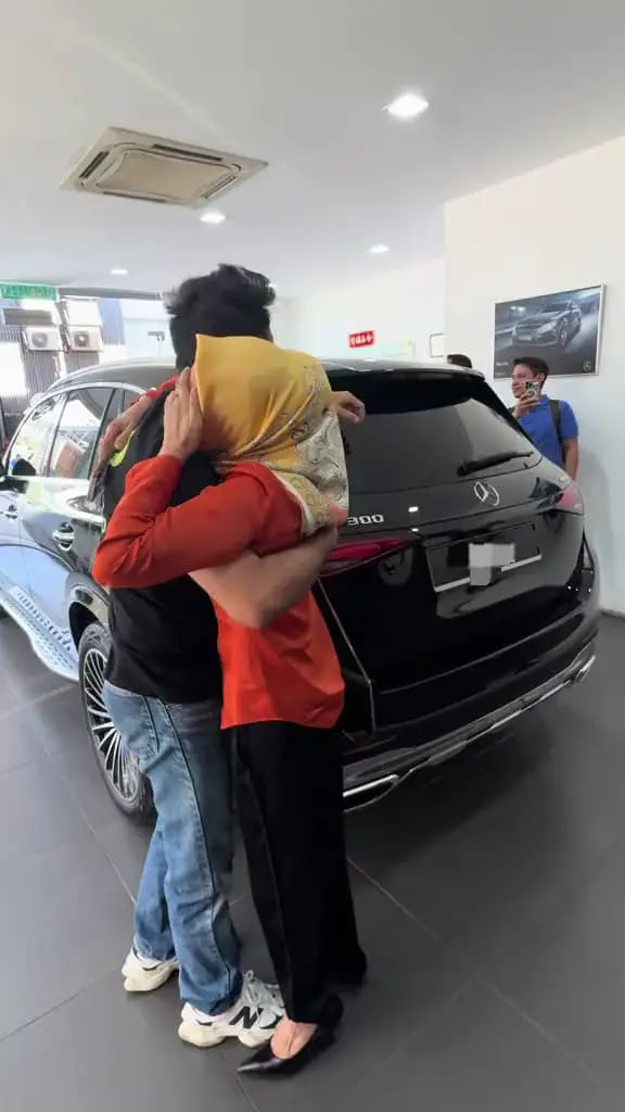 a mother crying while hugging her son after getting new car