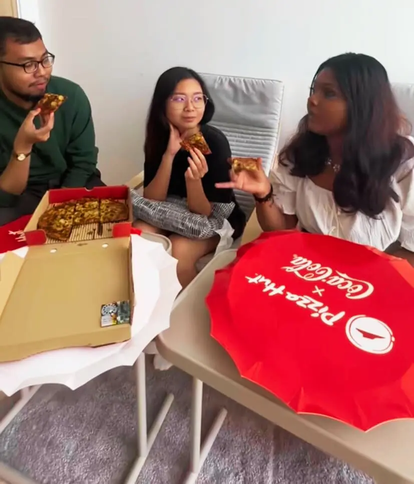 Team WeirdKaya happily eating Cola Pizza