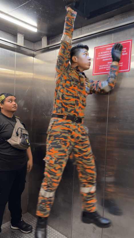 abang bomba coming through the lift roof to save people who were stuck in it