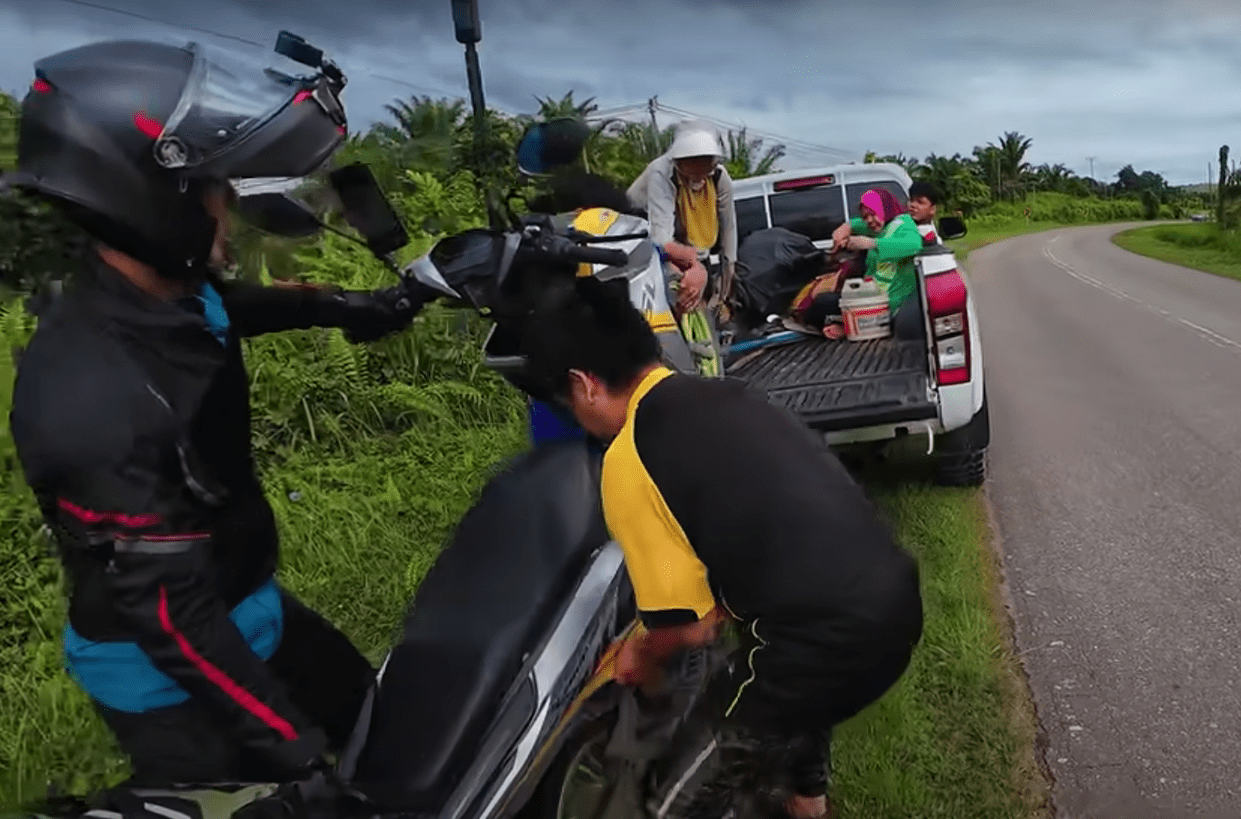 Abang carrying the motorcycle