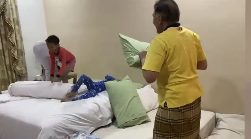 Anwar throwing pillows at grandkids