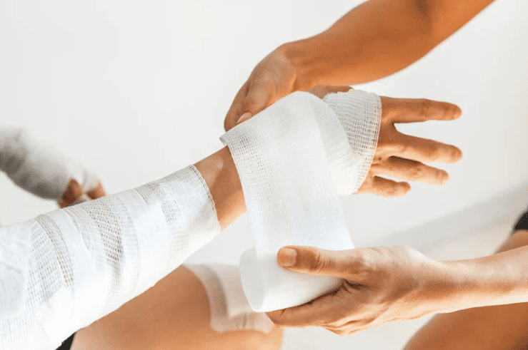An injured wrist being wrapped up