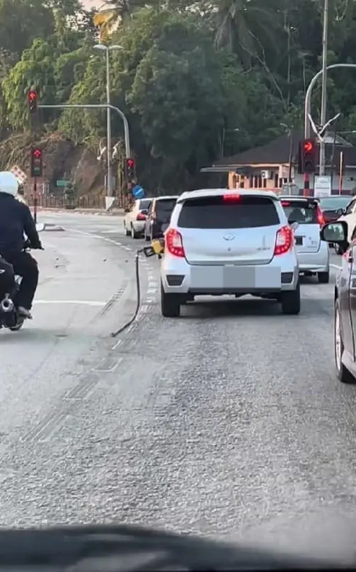 axia with hanging petrol nozzle