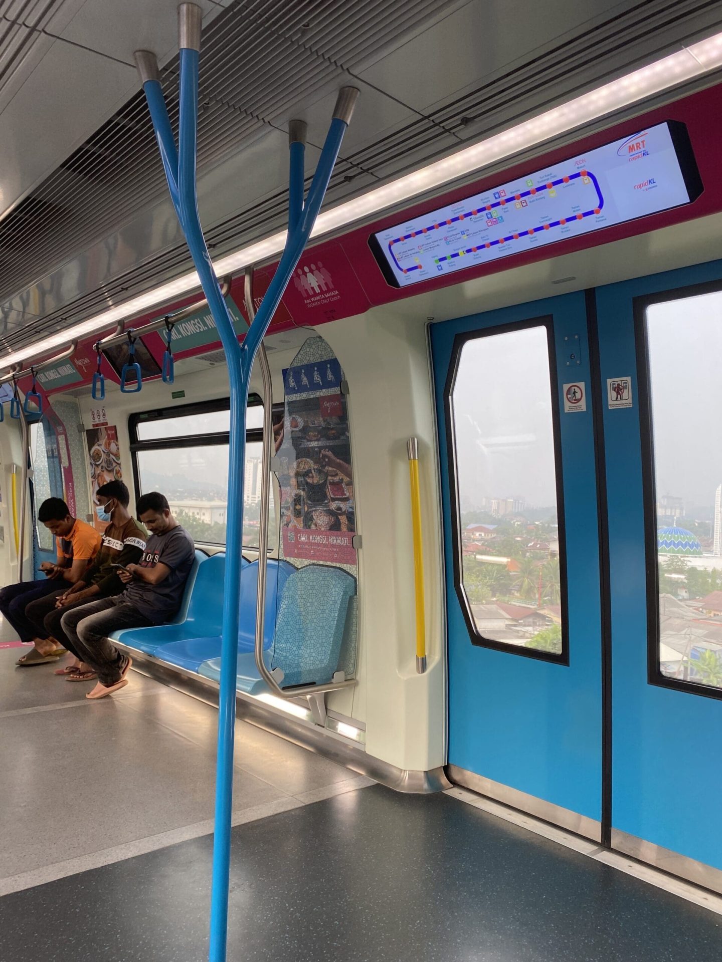 Men sitting in MRT Women coach