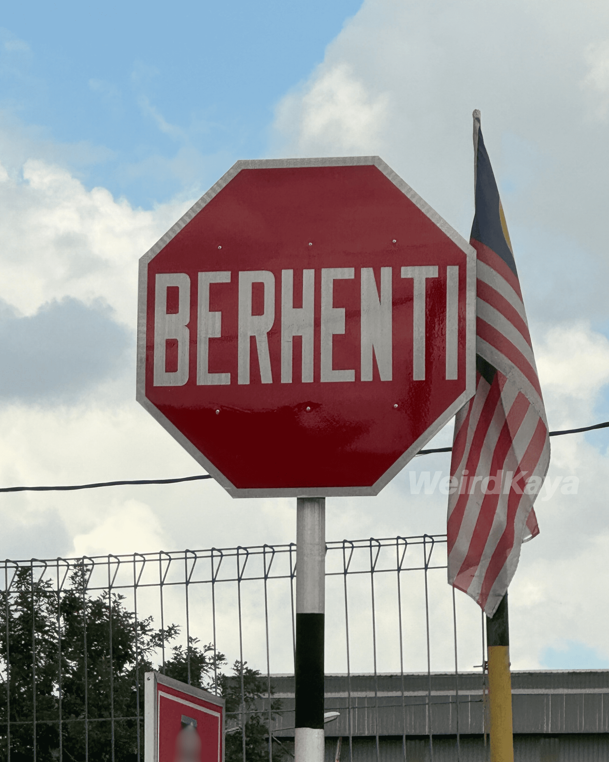 Berhenti road sign