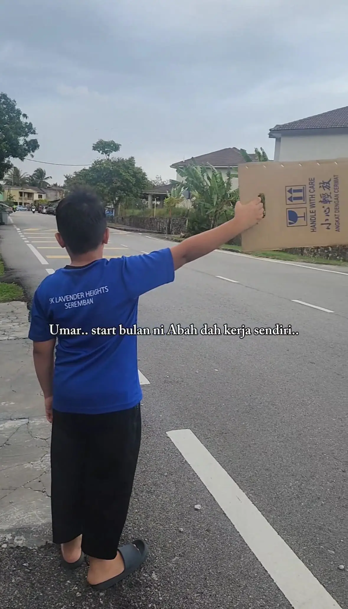 boy holding placard to promote his father's stall