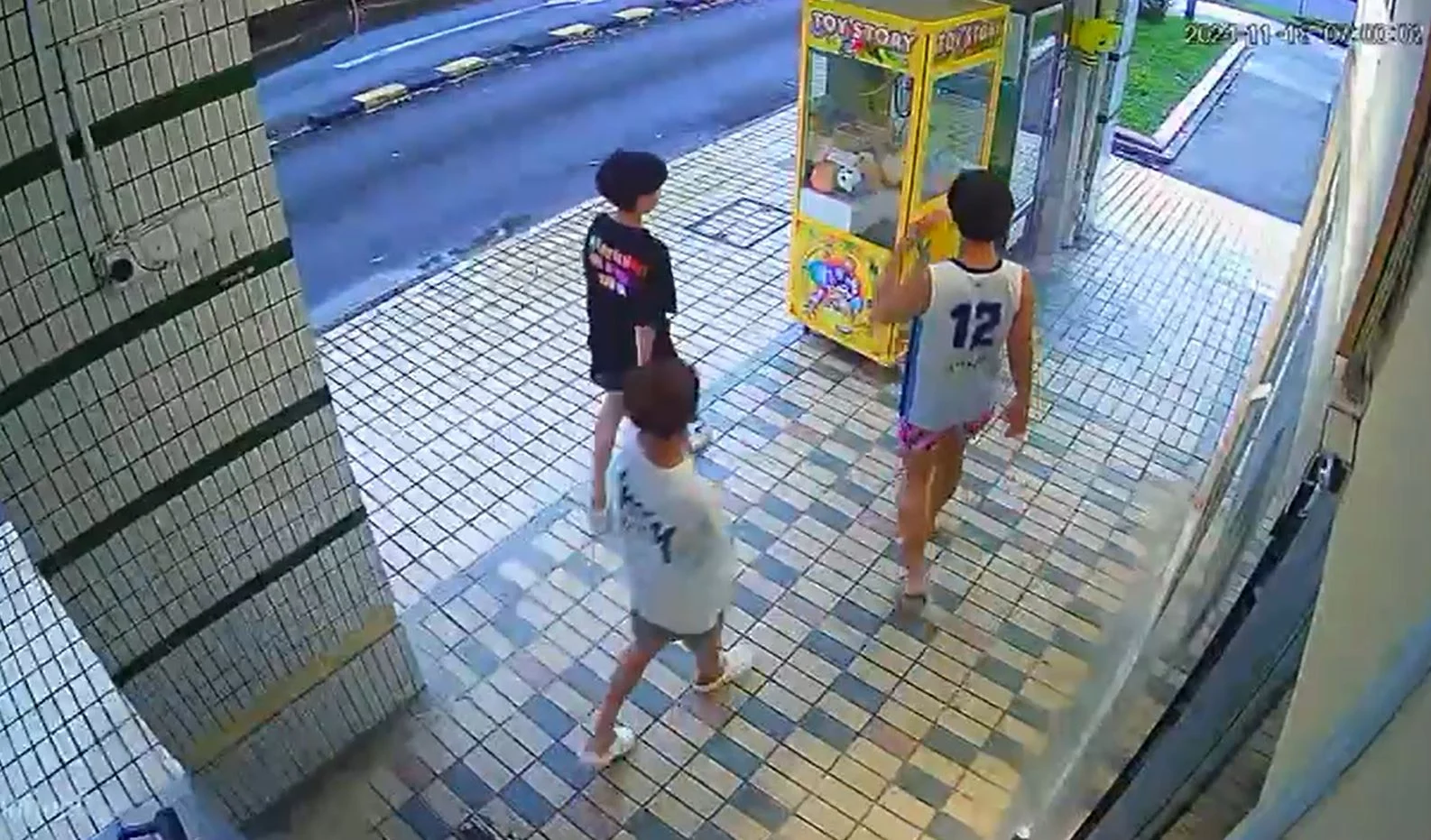 Boys playing with Labubu claw machine