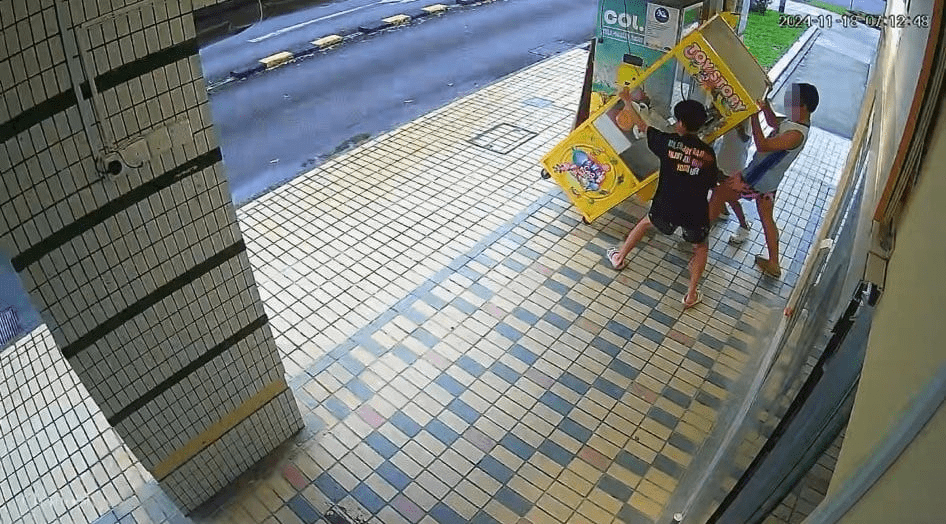 Boys tilt claw machine in different direction