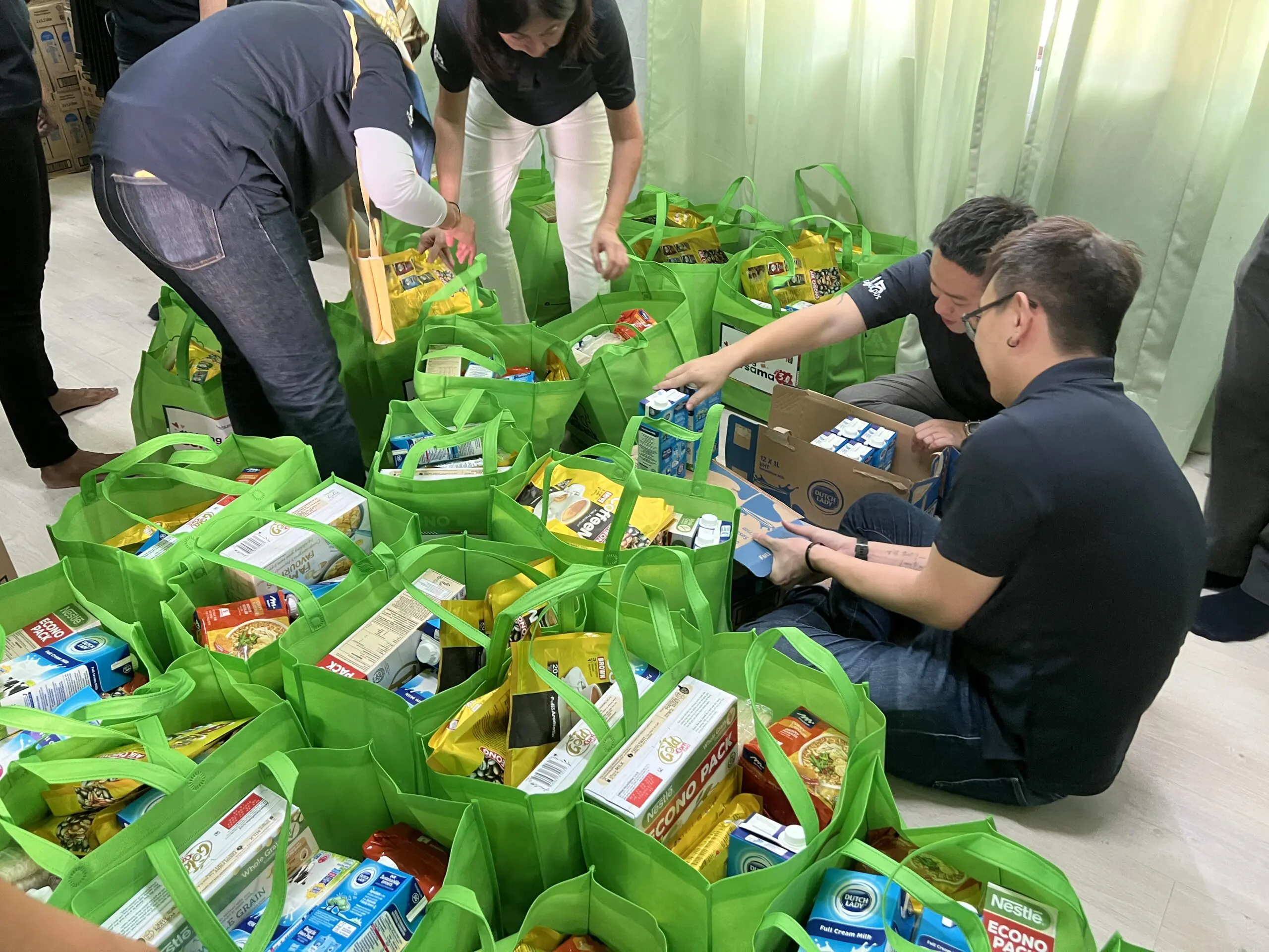 CapitaLand staff volunteers moving and packing  donation items 1