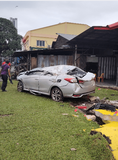 Car damaged after reversing into temple pillar