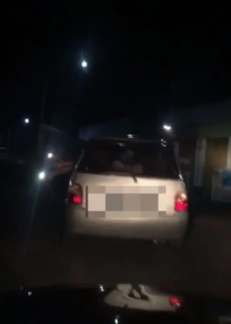 car using flashlight as signal