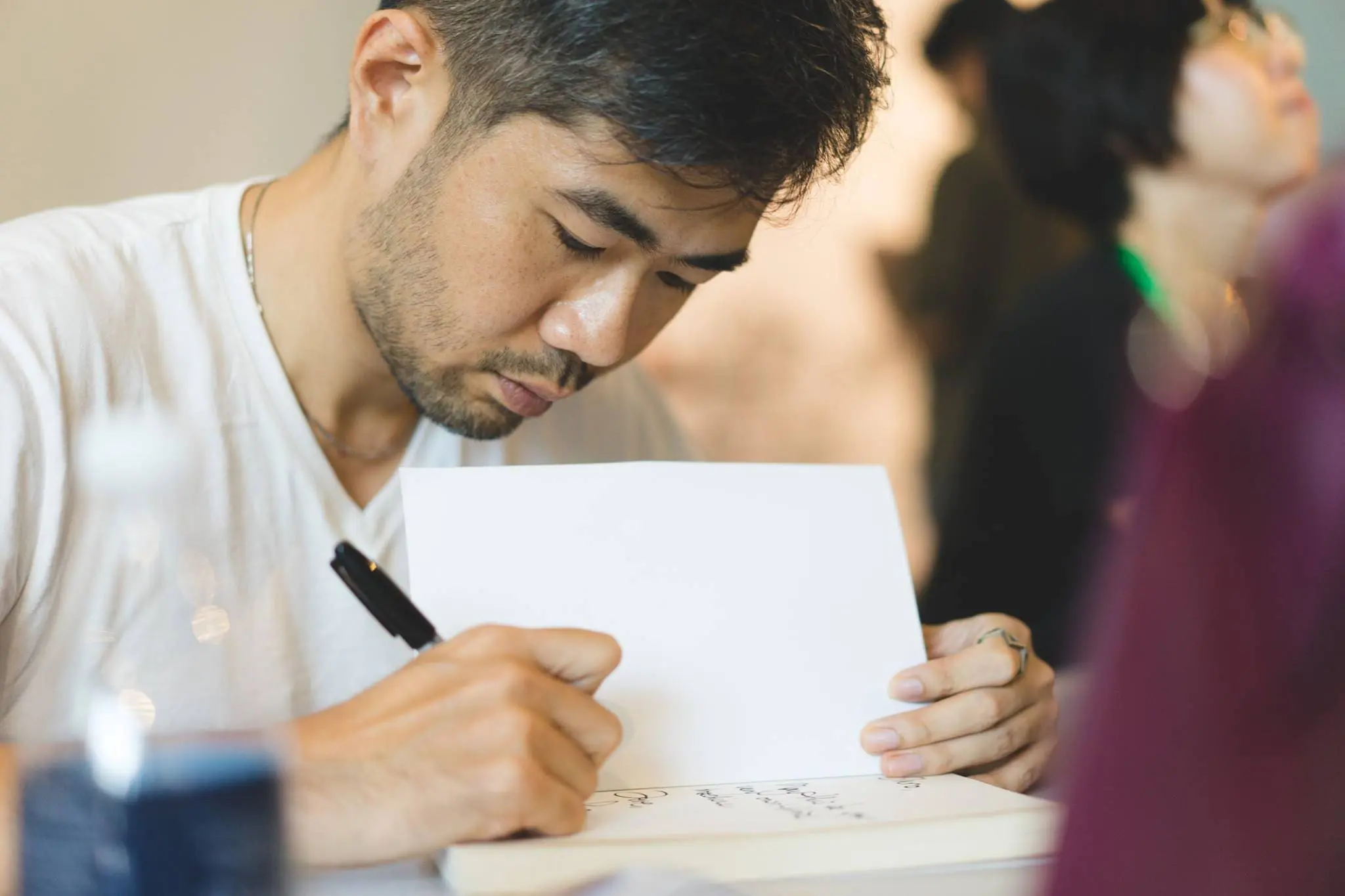 Cheeming Boey signing a book