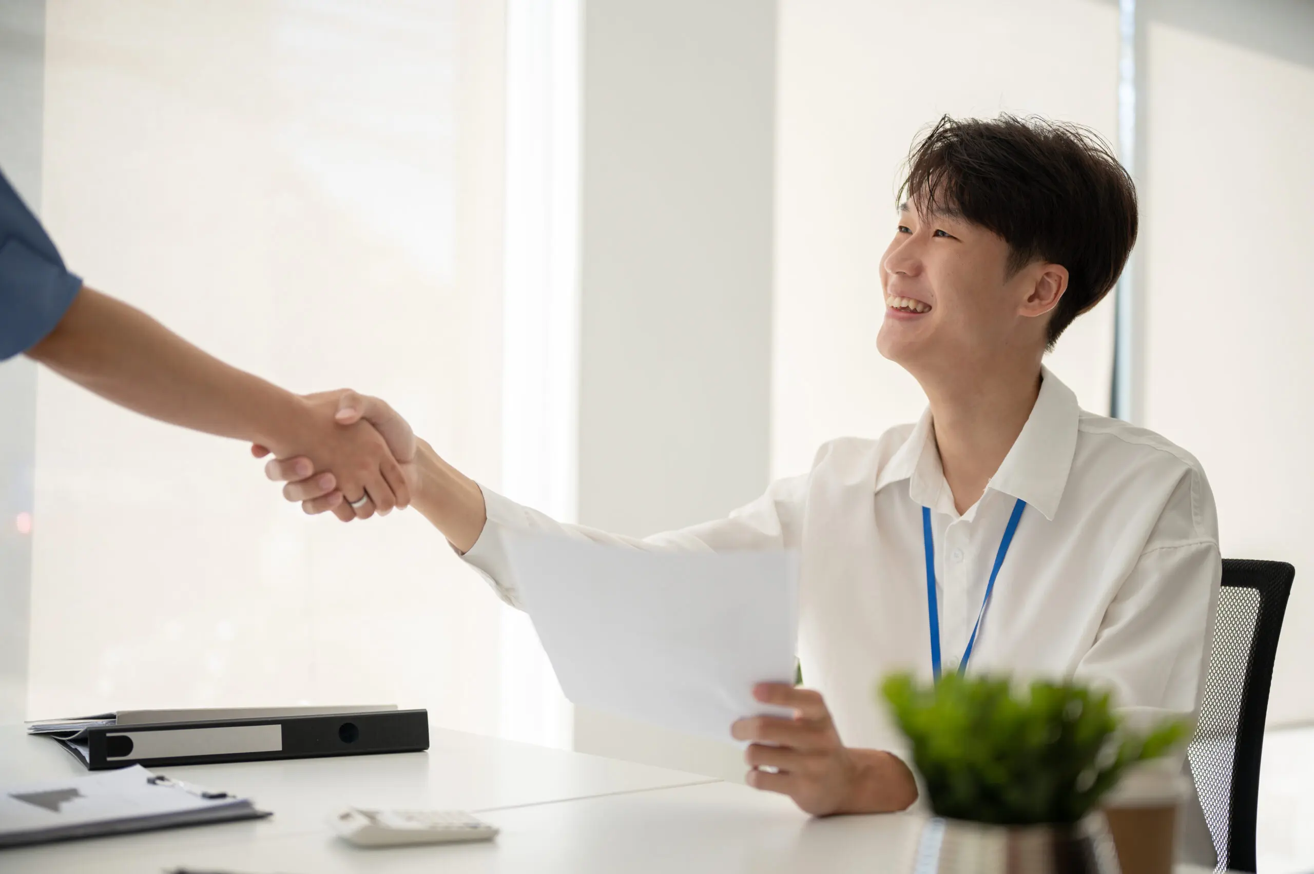 A man shaking hand with another person