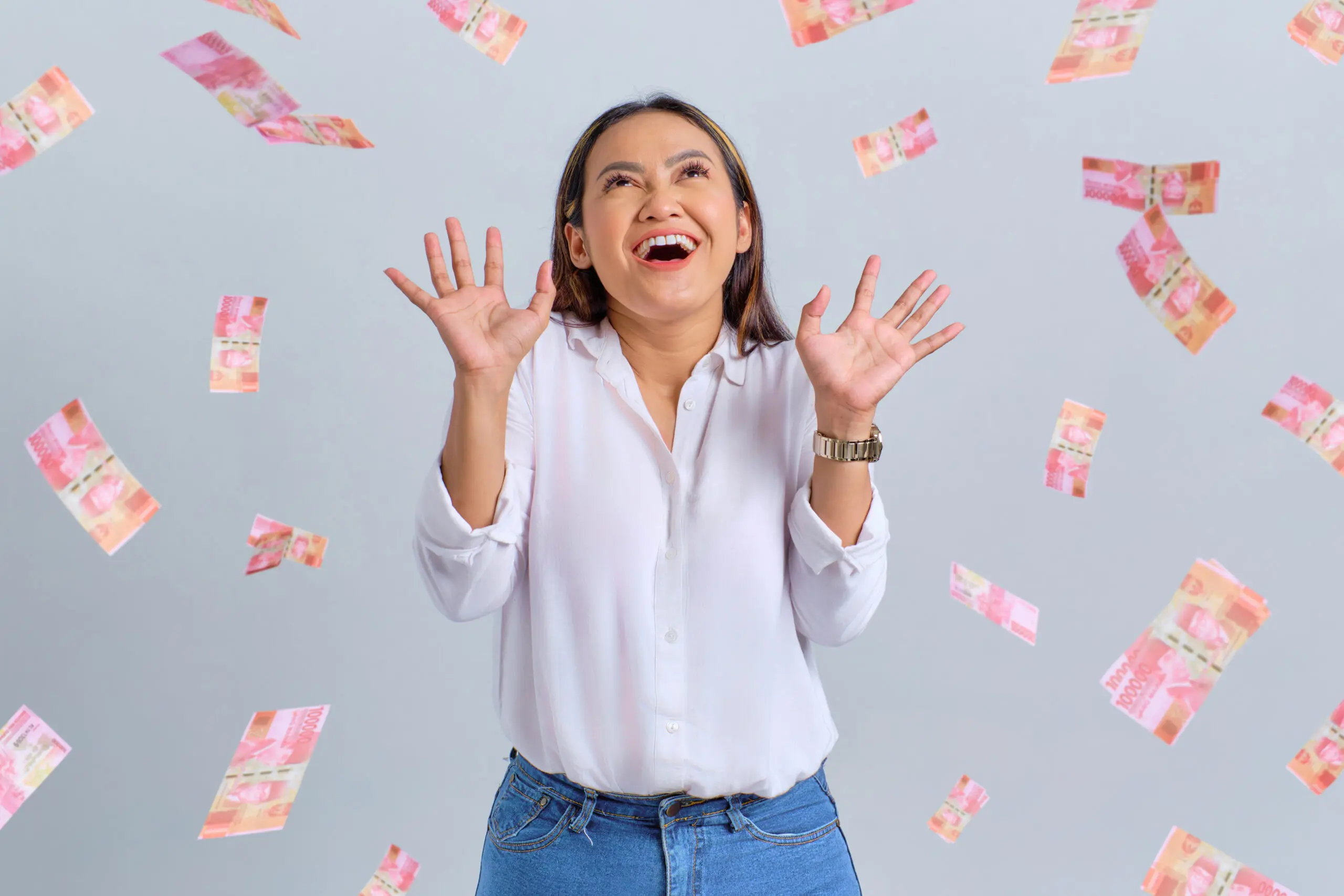 Happy woman with money raining down