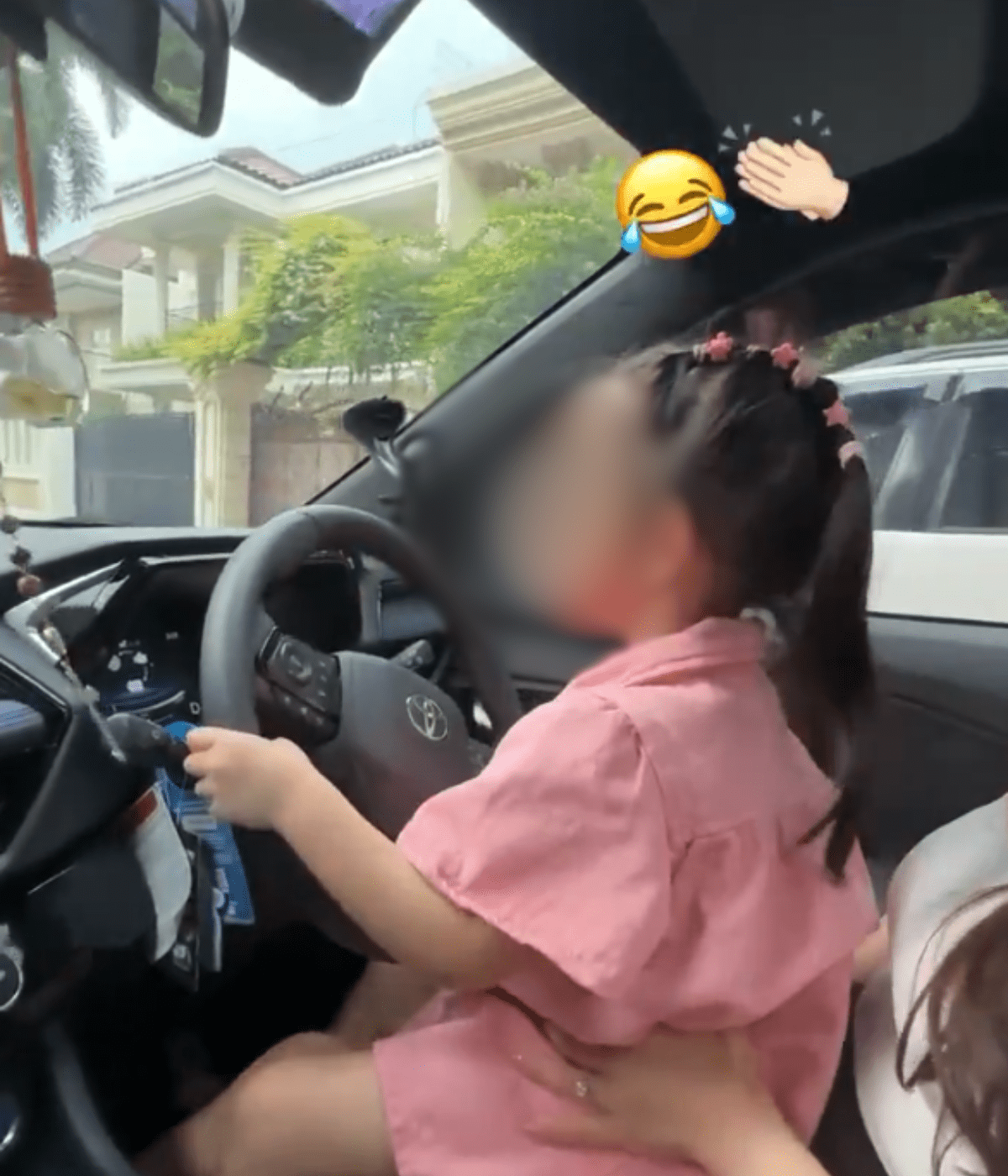 Child steering the car in indonesia