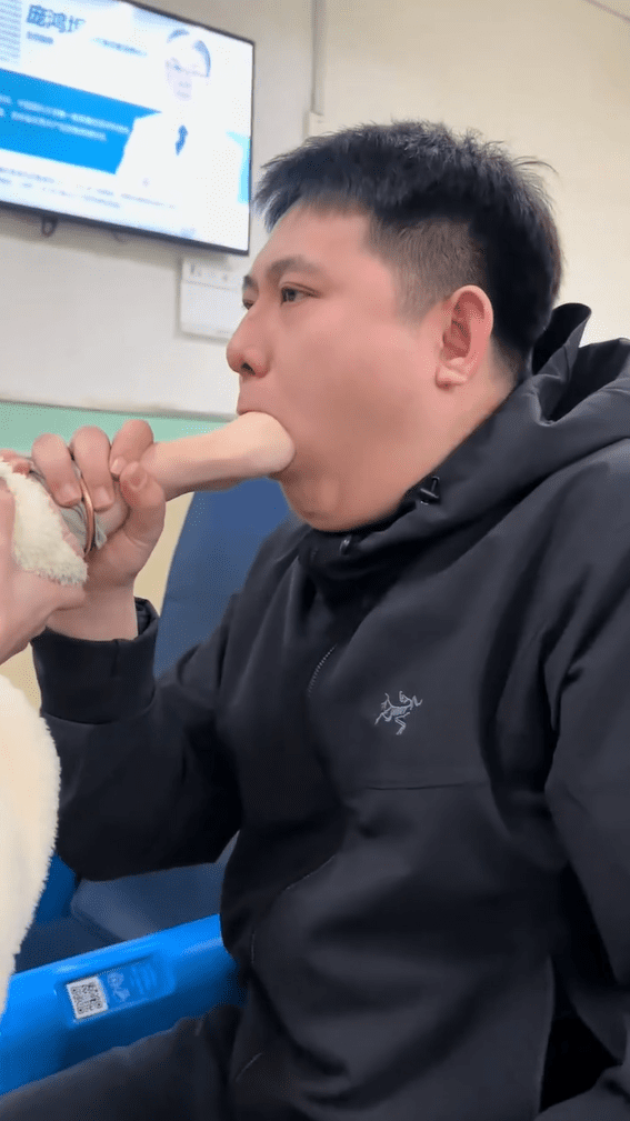 China man salivates with hand inside mouth