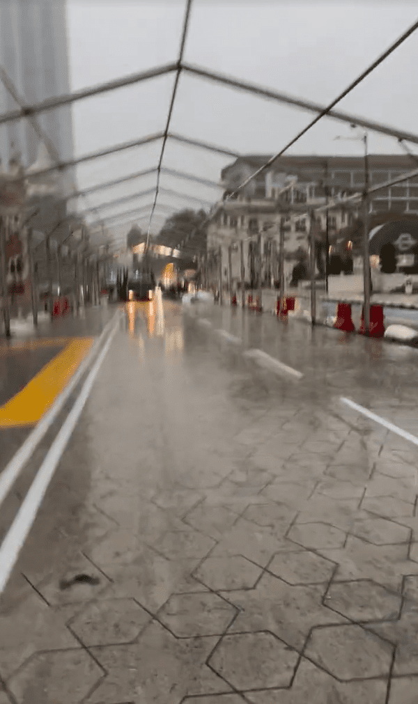 China tourist running in the rain near Merdeka Square