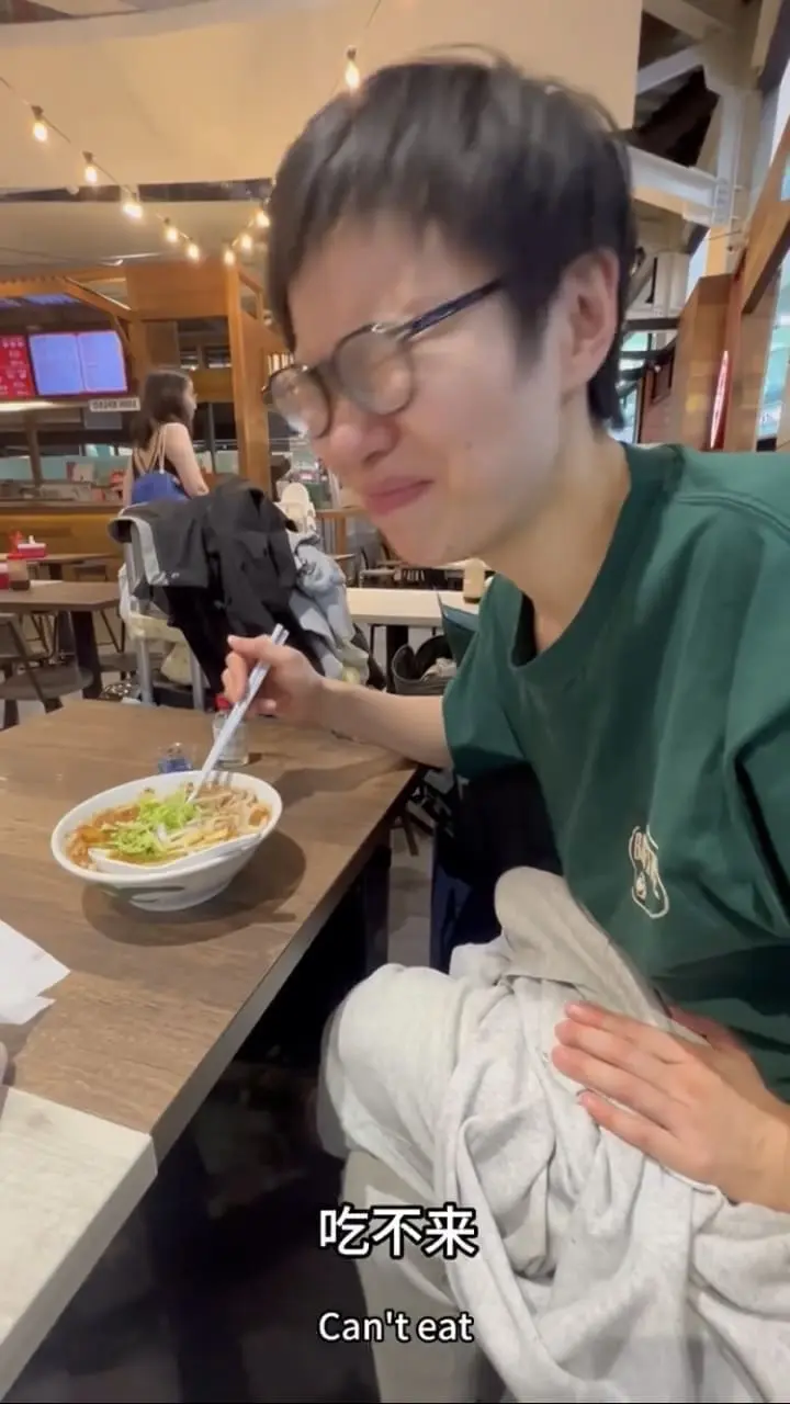 China woman makes a face after eating asam laksa