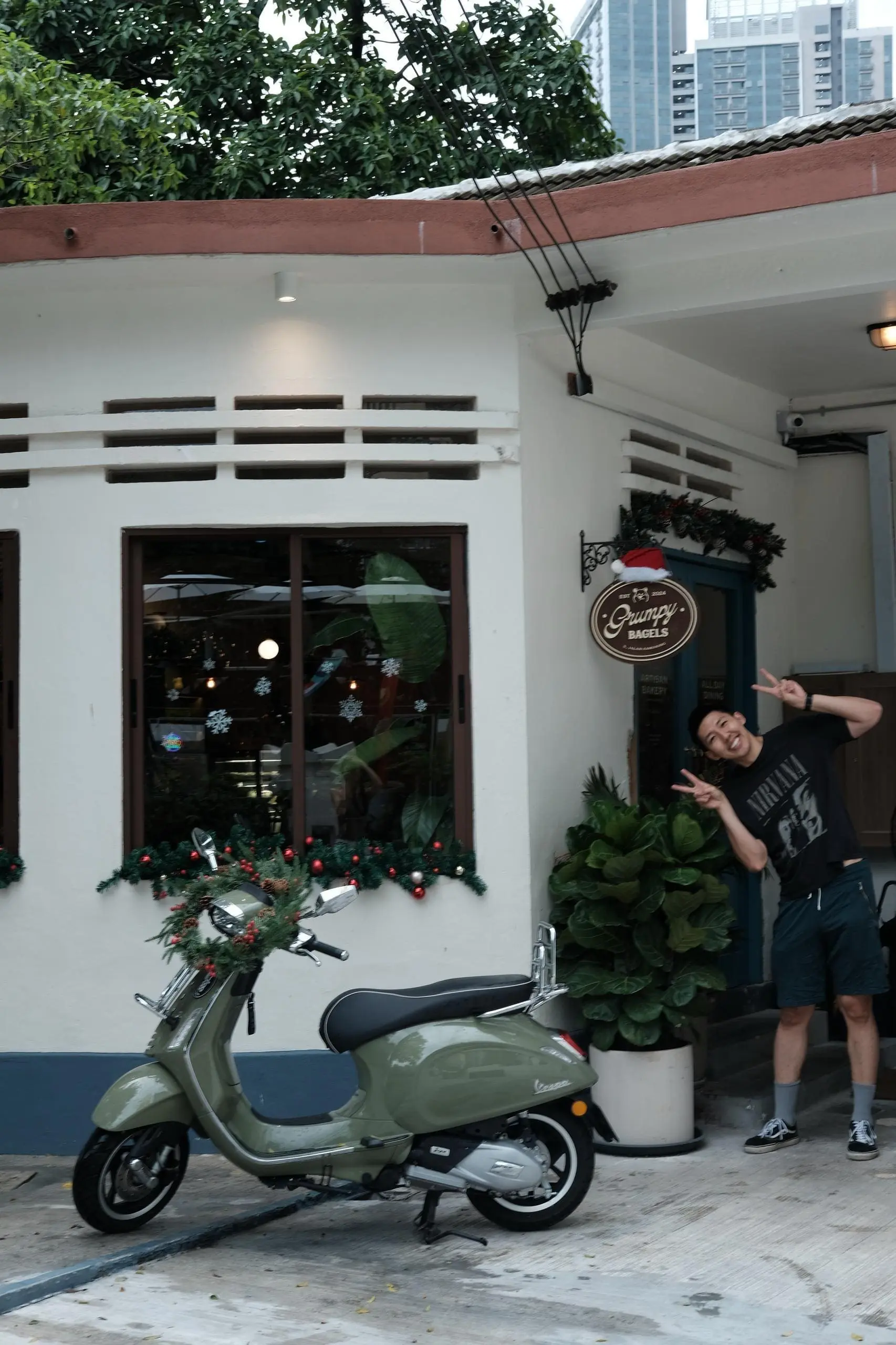 Claire's husband posing in front of Grumpy Bagels