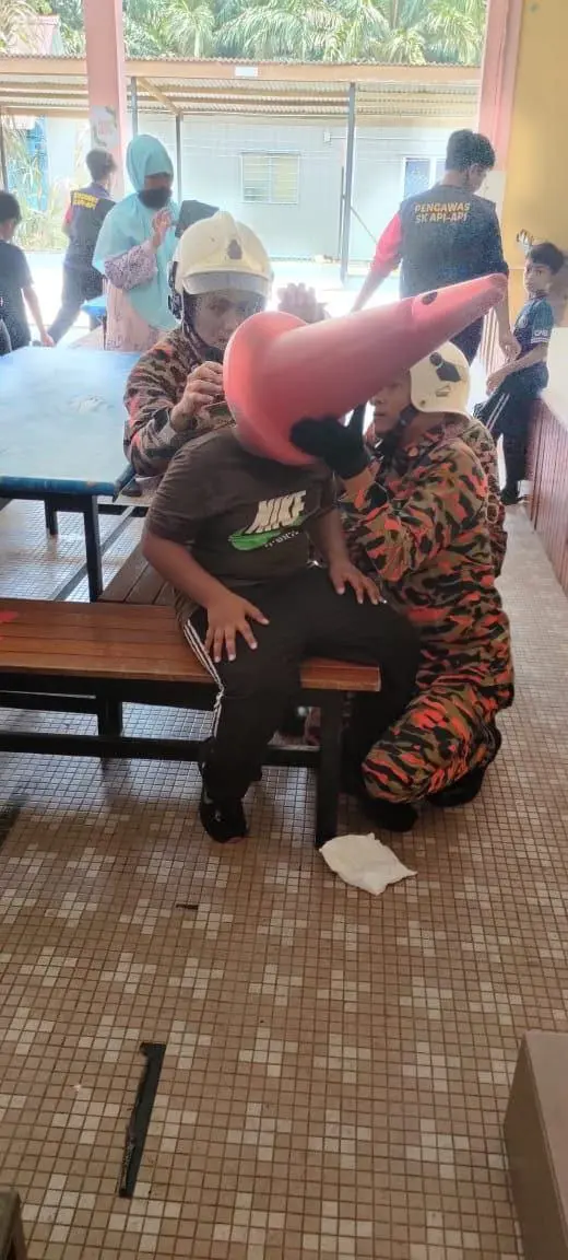 Johor firefighters free boy's head from traffic cone