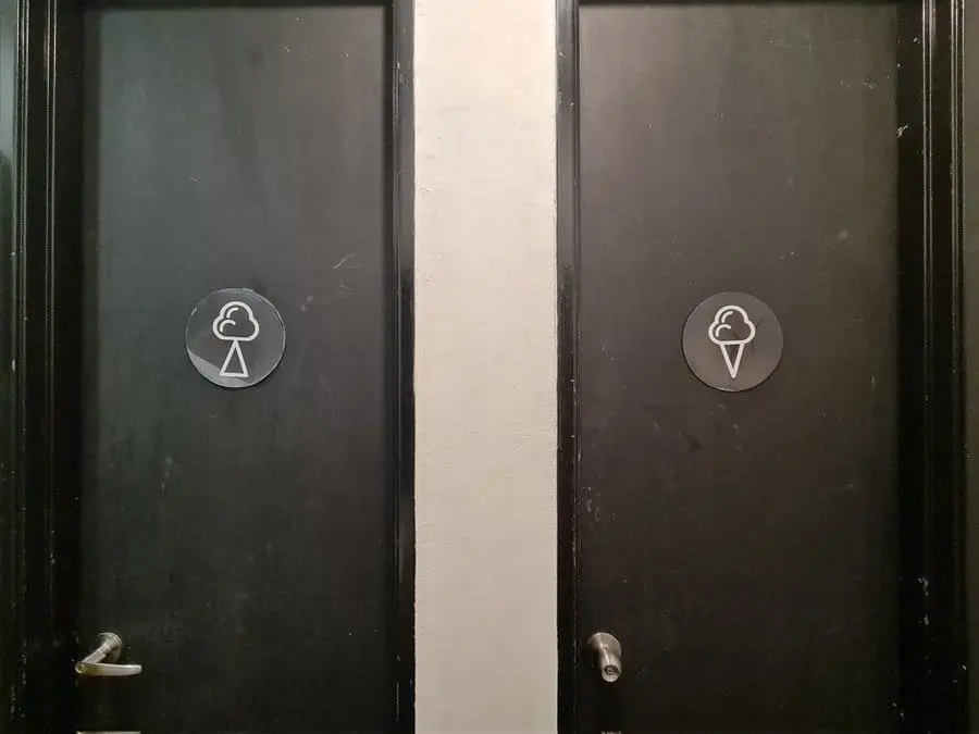 Confusing toilet sign featuring a cloud and triangle