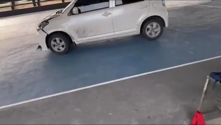 Crashes the car into the basketball court