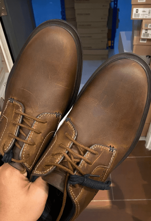 Damaged leather shoes get polished
