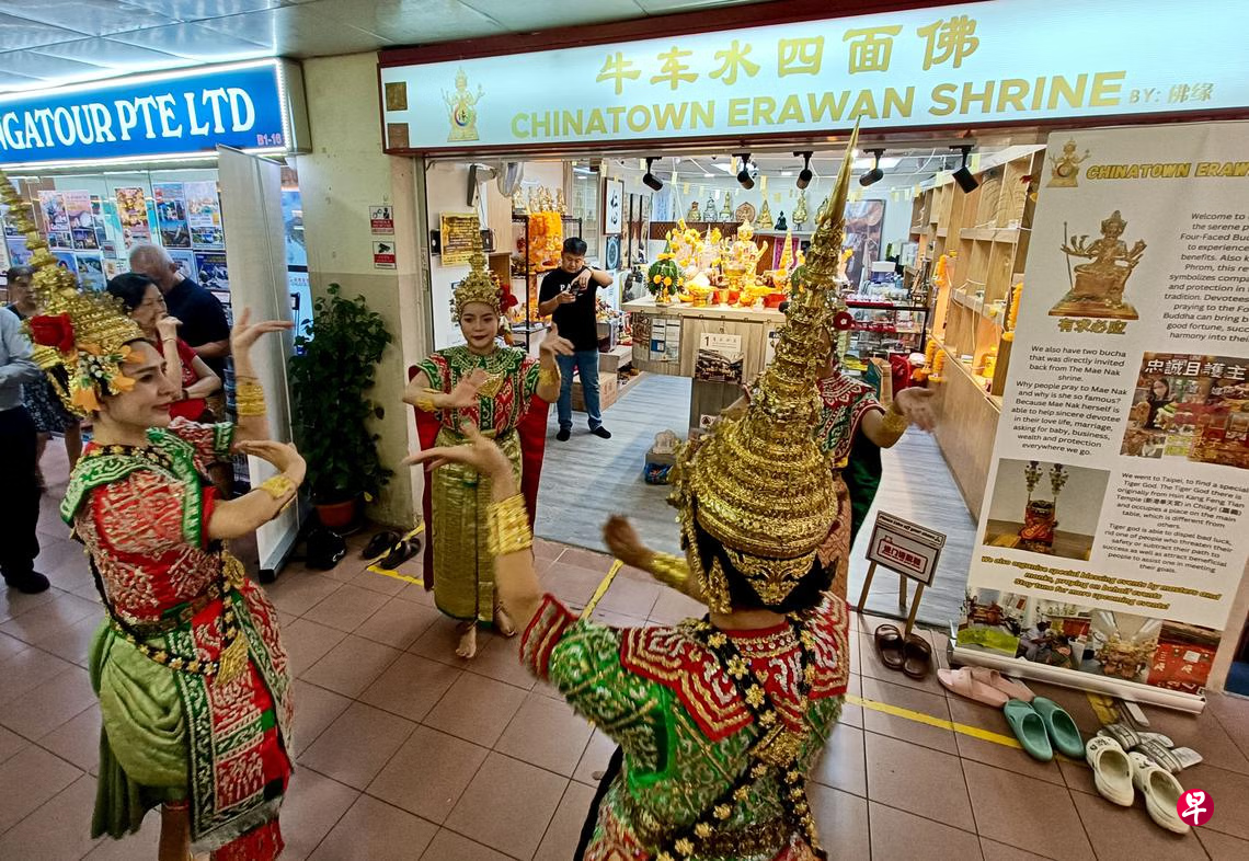 Dancers performing in front of Chinatown Erawan Shrine