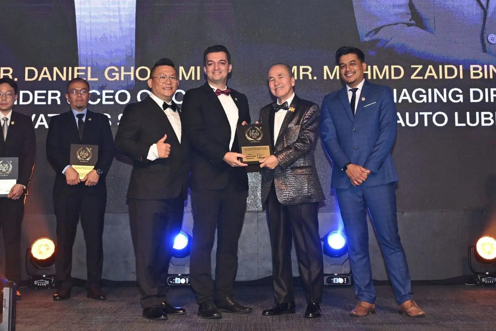 Daniel Gholami receiving a token of appreciation