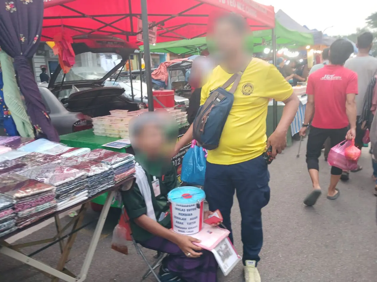 disabled beggar sitting at a market in johor