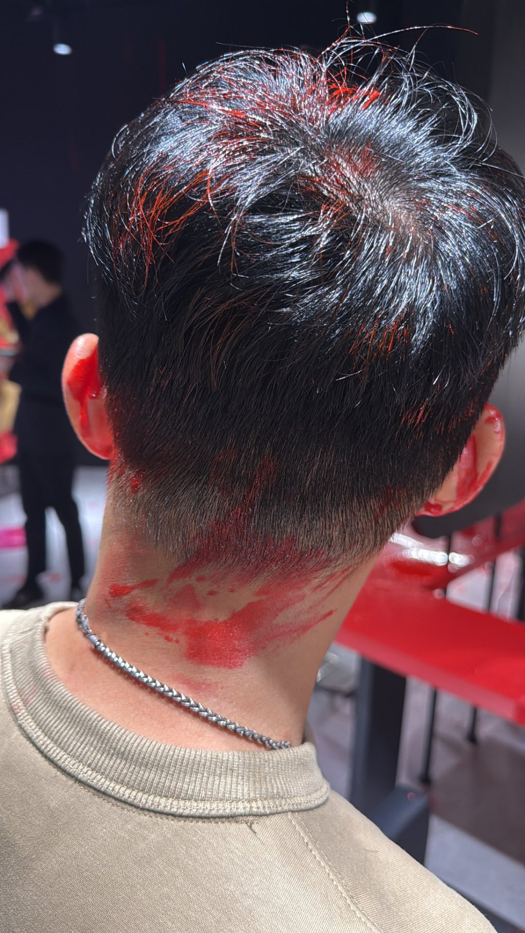 Douglas Ang's hair in red paint