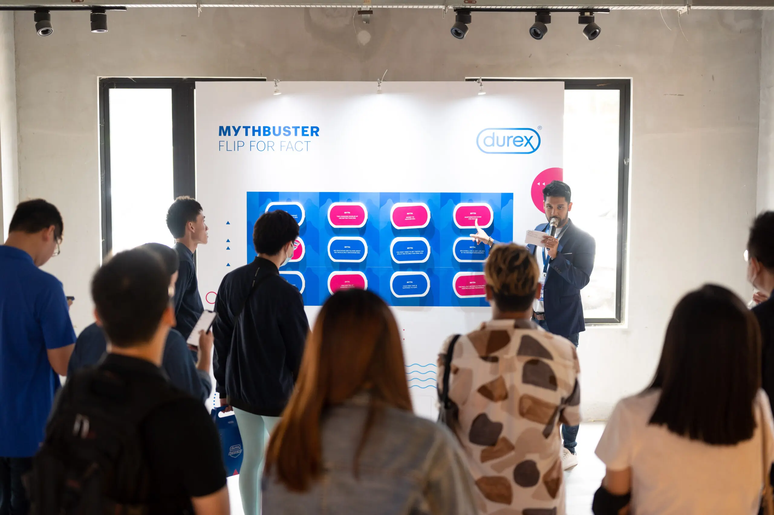 Durex Academy host giving a talk on myth vs fact for sex ed.