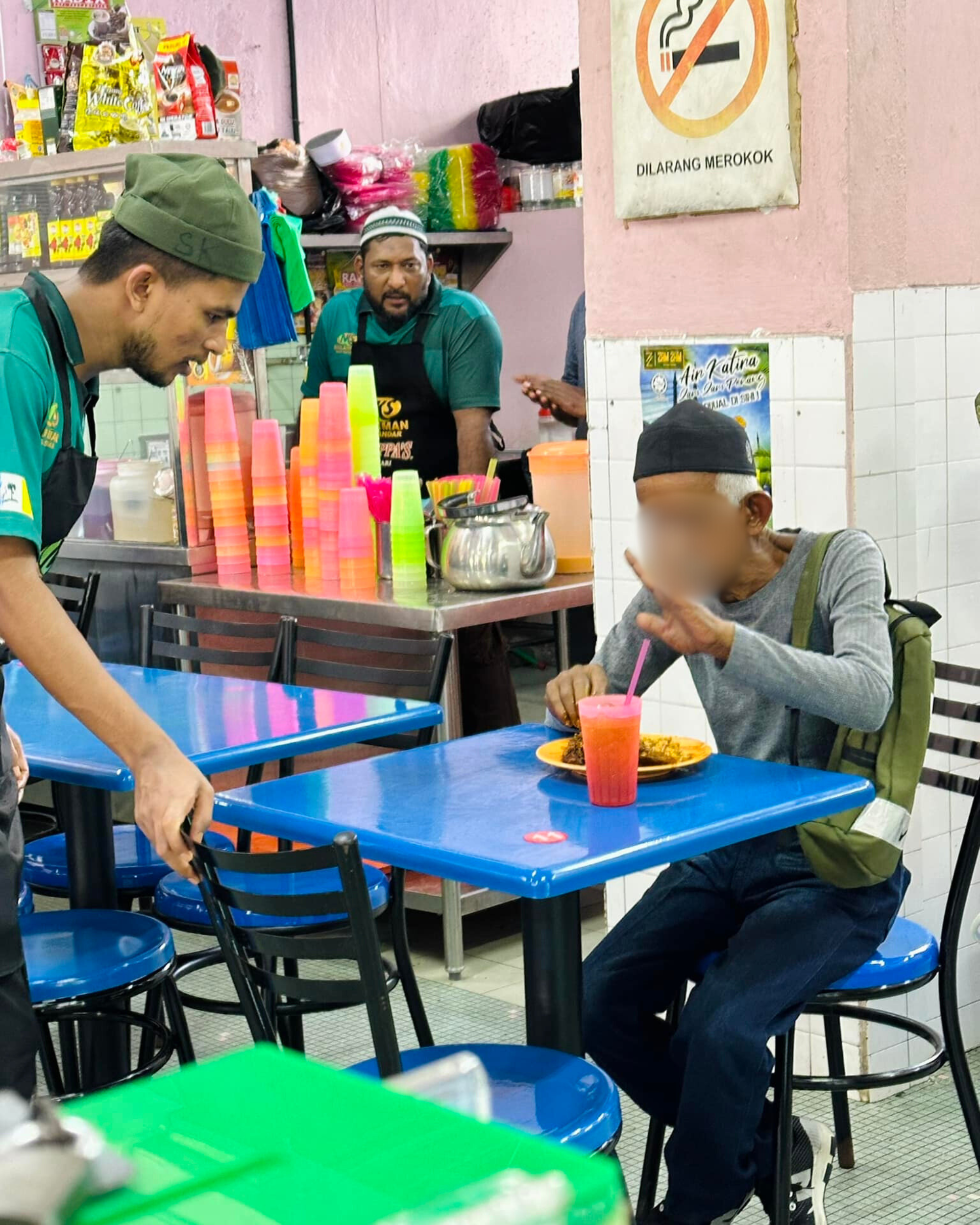 Elder man eating in mamak