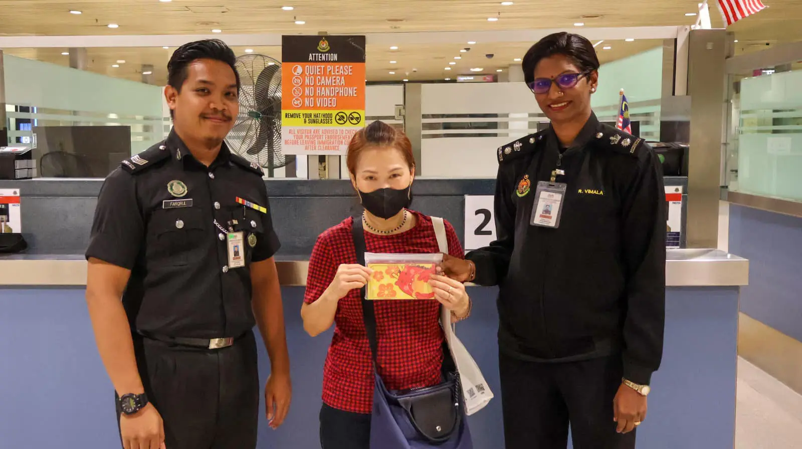 ELderly woman with Johor Immigration Officers