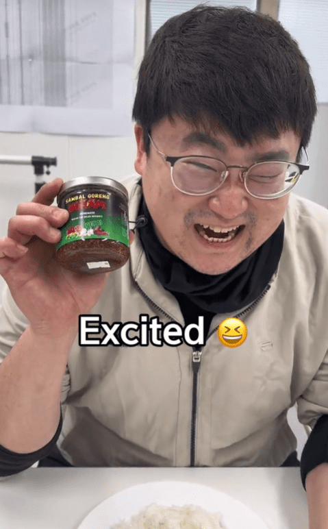 Excited Korean man with a bottle of sambal