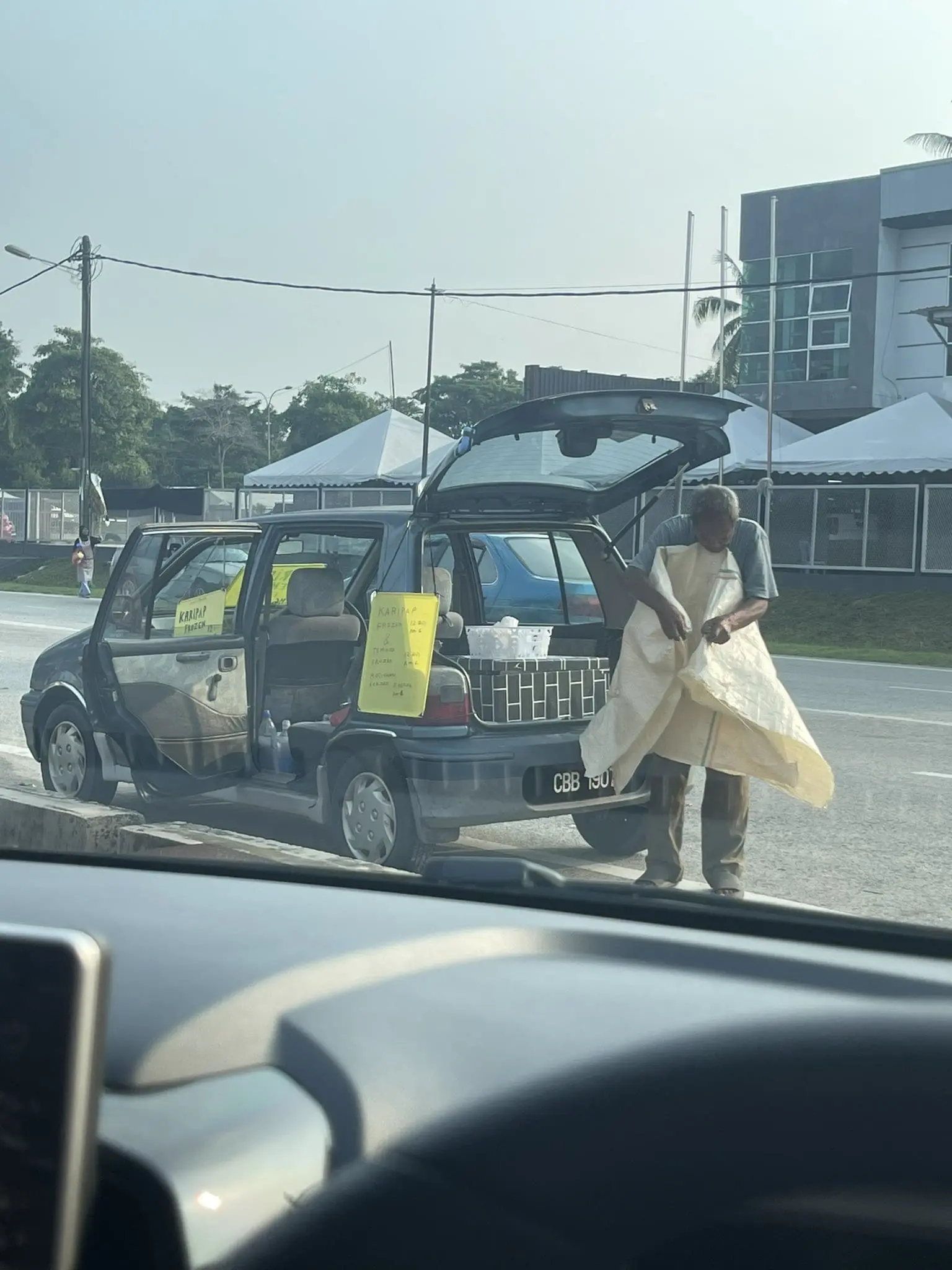Malaysian uncle folding a fabric 