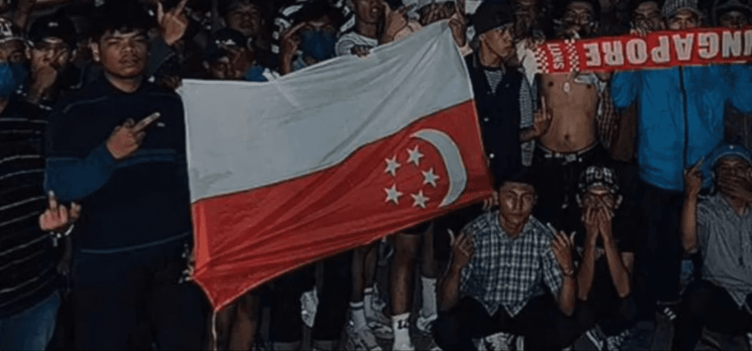 Fans pose with upside down SG flag